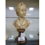 A 19th century waxwork bust of a boy on