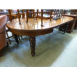 An Edwardian walnut extending dining tab