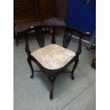 An Edwardian walnut corner chair with ca