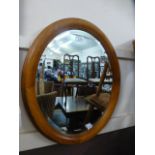 A modern pine framed oval mirror