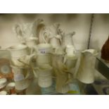 A collection of white ceramic jugs to in