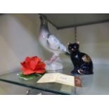 A ceramic model of a pigeon together wit