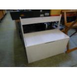 A white painted storage bench