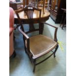 An Edwardian mahogany open armchair havi