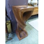 A carved hardwood stand with twist desig