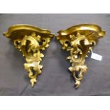 A pair of gilt painted scrolling floral