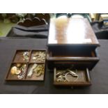 A jewellery box containing an assortment