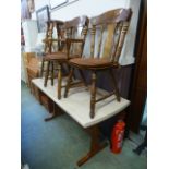 A set of three kitchen chairs along with