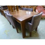 A modern oak extending dining table alon