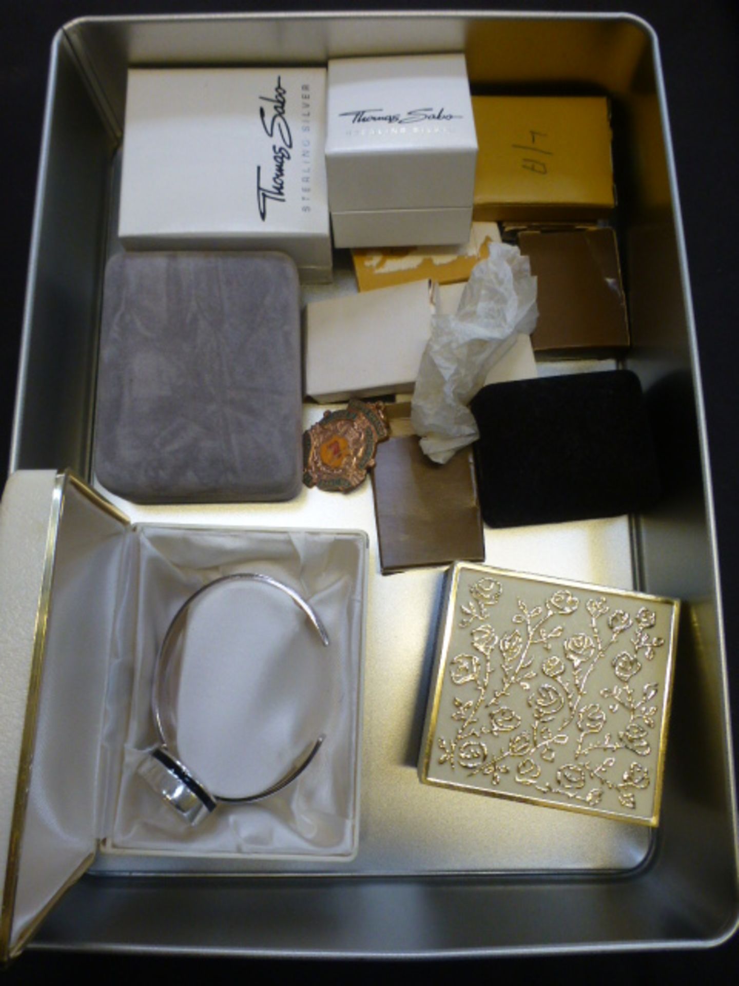 A box containing silver and white metal