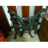 Two green painted cast metal bench ends