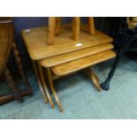 A nest of three Ercol style tables with