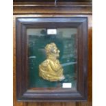 A framed and glazed gilt metal relief of