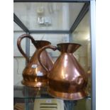 A large copper jug together with one sma