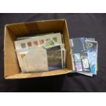 A box of assorted stamps and stamp cover