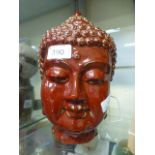 A red painted ceramic eastern head