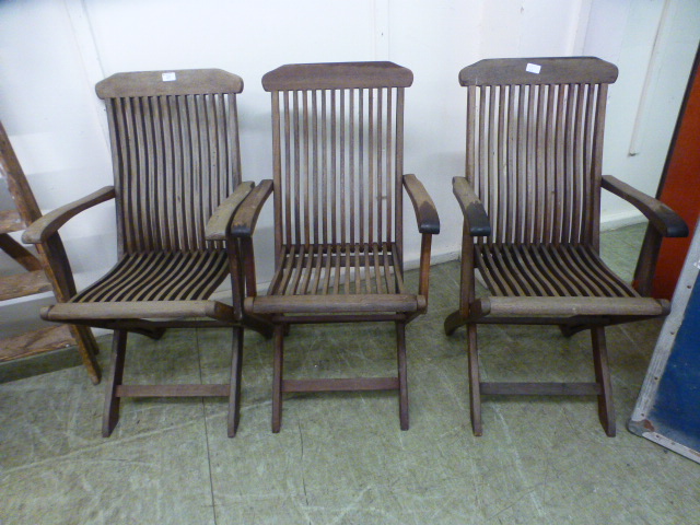 A set of three teak folding garden chair