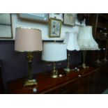 Four assorted brass table lamps