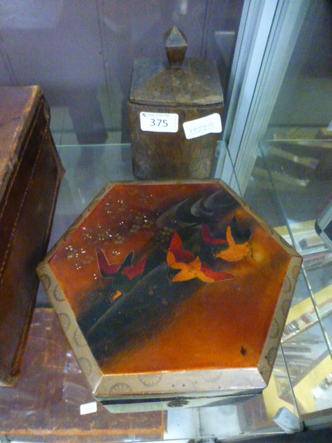 A lacquered six sided lidded box togethe