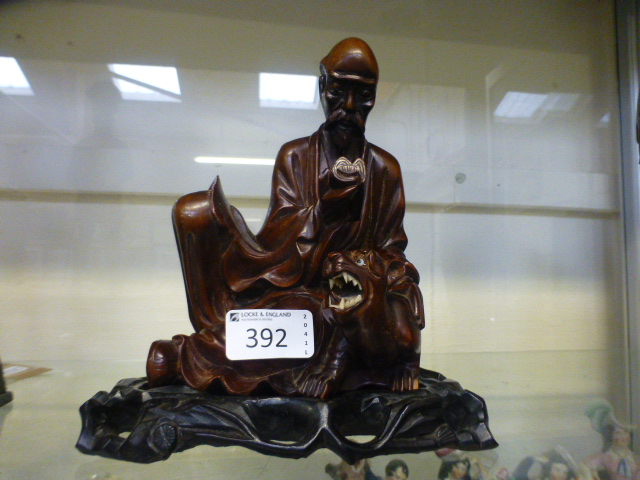 A carved Chinese Buddha on plinth