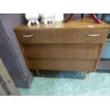 A mid 20th century teak three drawer che