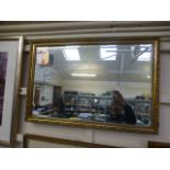 A gilt framed bevel glass wall mirror