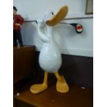 A papier mache model of a duck playing g