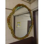 A moulded floral framed mirror