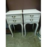 A pair of cream and parcel gilt bedside