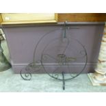 A wrought metal plant pot holder in the