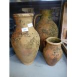 Three earthenware vases, two with handle