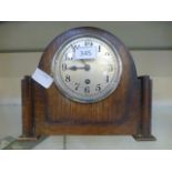 An oak cased mantle clock