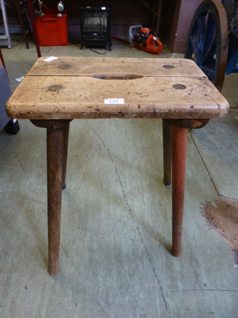 An early 20th century wooden stool