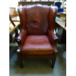 An early 20th century wing arm chair uph