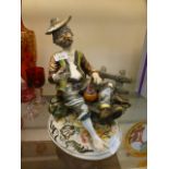A Capodimonte figure of a gentleman on a