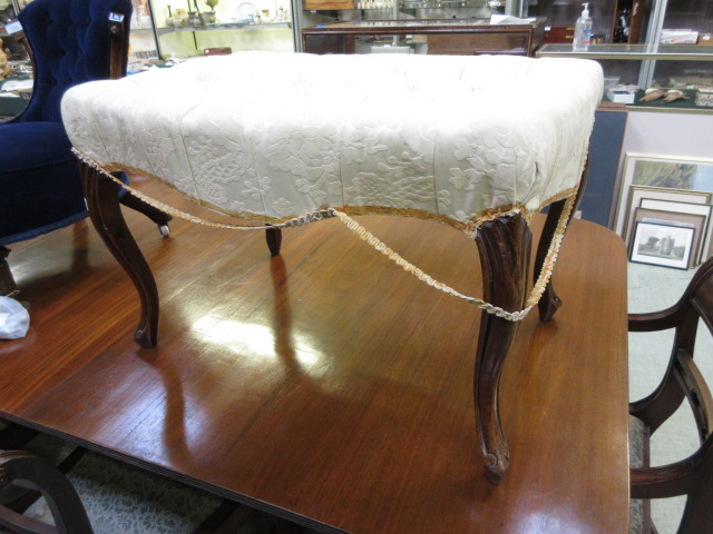 An early 20th century mahogany stool wit