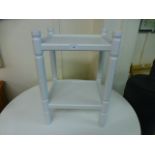 A white painted two tier stand