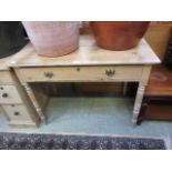 A waxed pine desk with single drawer