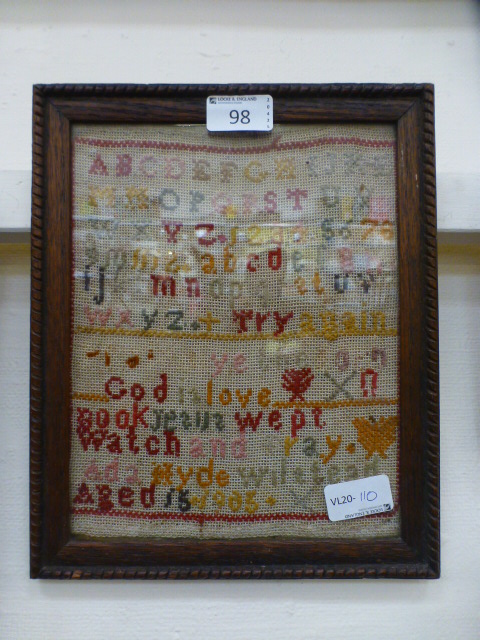 An oak framed and glazed sampler, dated