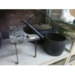 A large cast metal lidded cook pan toget