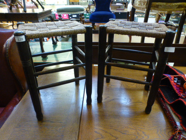 A pair of stools with sea grass seats