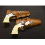 A pair of western style toy guns