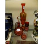 Five items of red cranberry glassware to