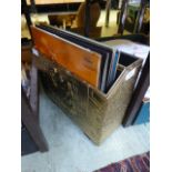 A hammered brass magazine rack with a co