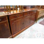 A reproduction yew sideboard having thre