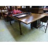 A mid 20th century oak drawer leaf table