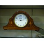 A small mahogany inlaid mantle clock