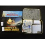 A tin containing trade cards together wi