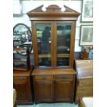 An Edwardian walnut bookcase, with two g