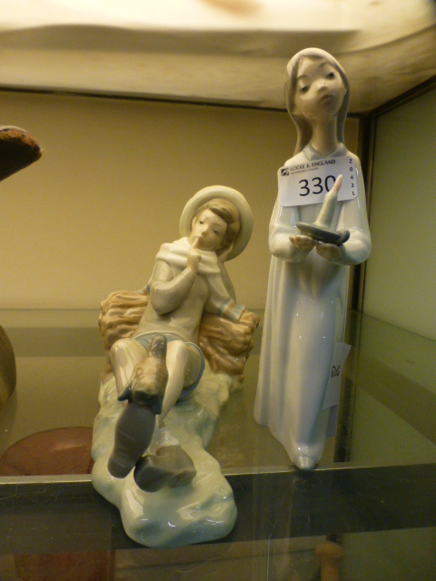 A Lladro figure of lounging boy with bir